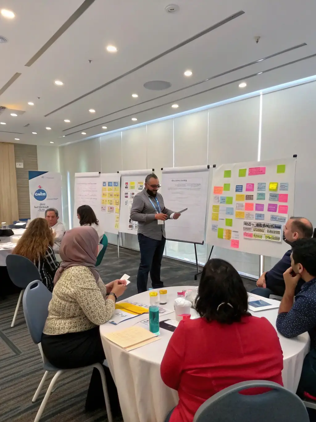 A consultant leading a workshop on change management, helping employees adapt to new processes and technologies.